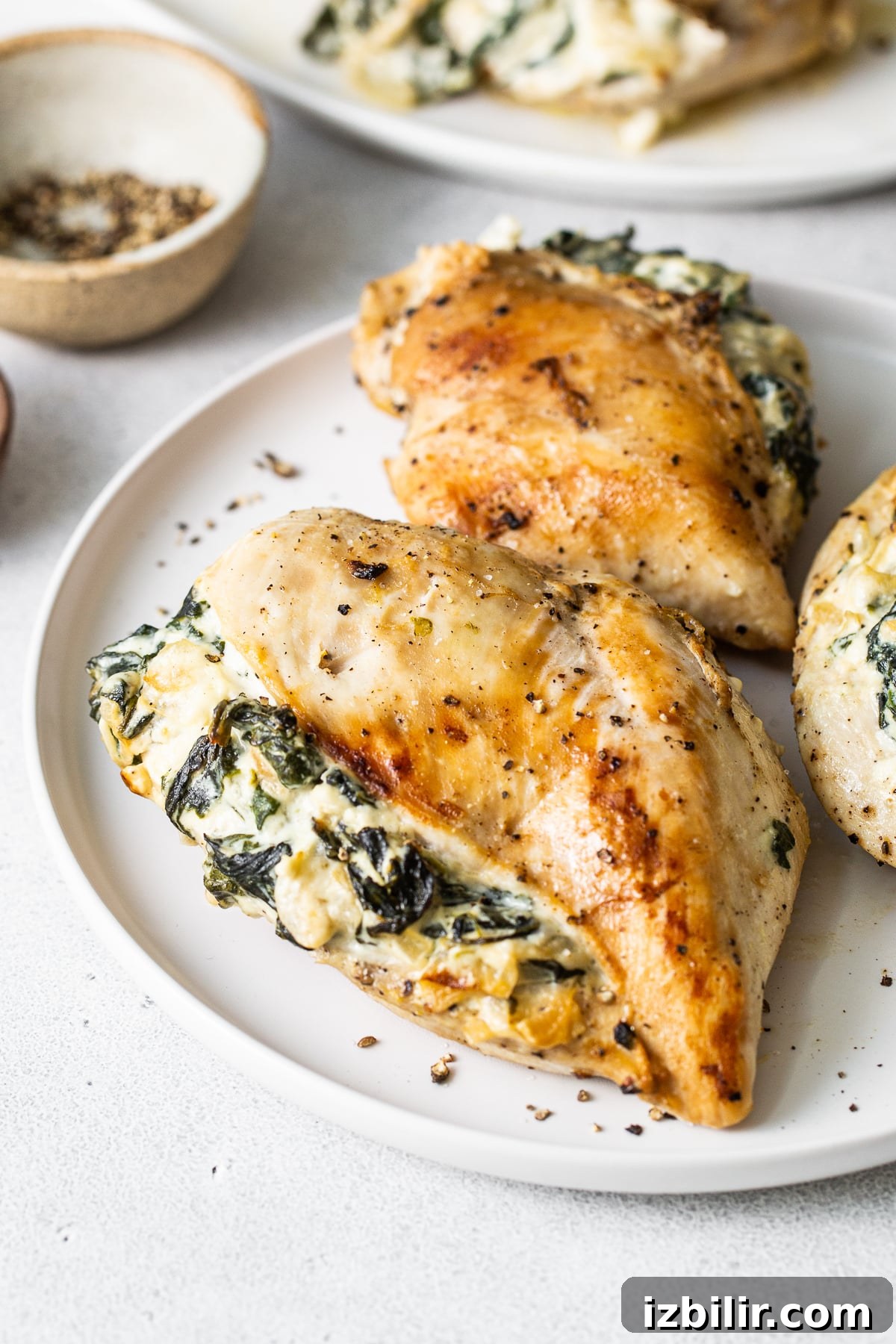 Spinach stuffed chicken breast Spinach stuffed chicken breast on a plate.
