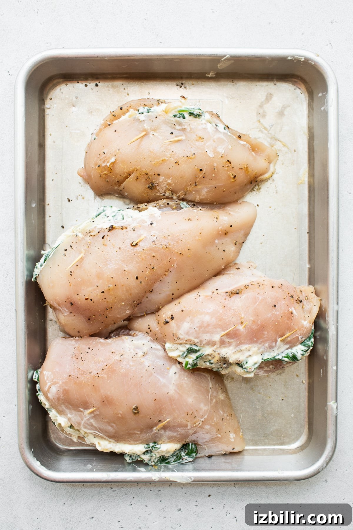 Stuffed chicken on baking sheet Stuffed chicken breast on a baking sheet.