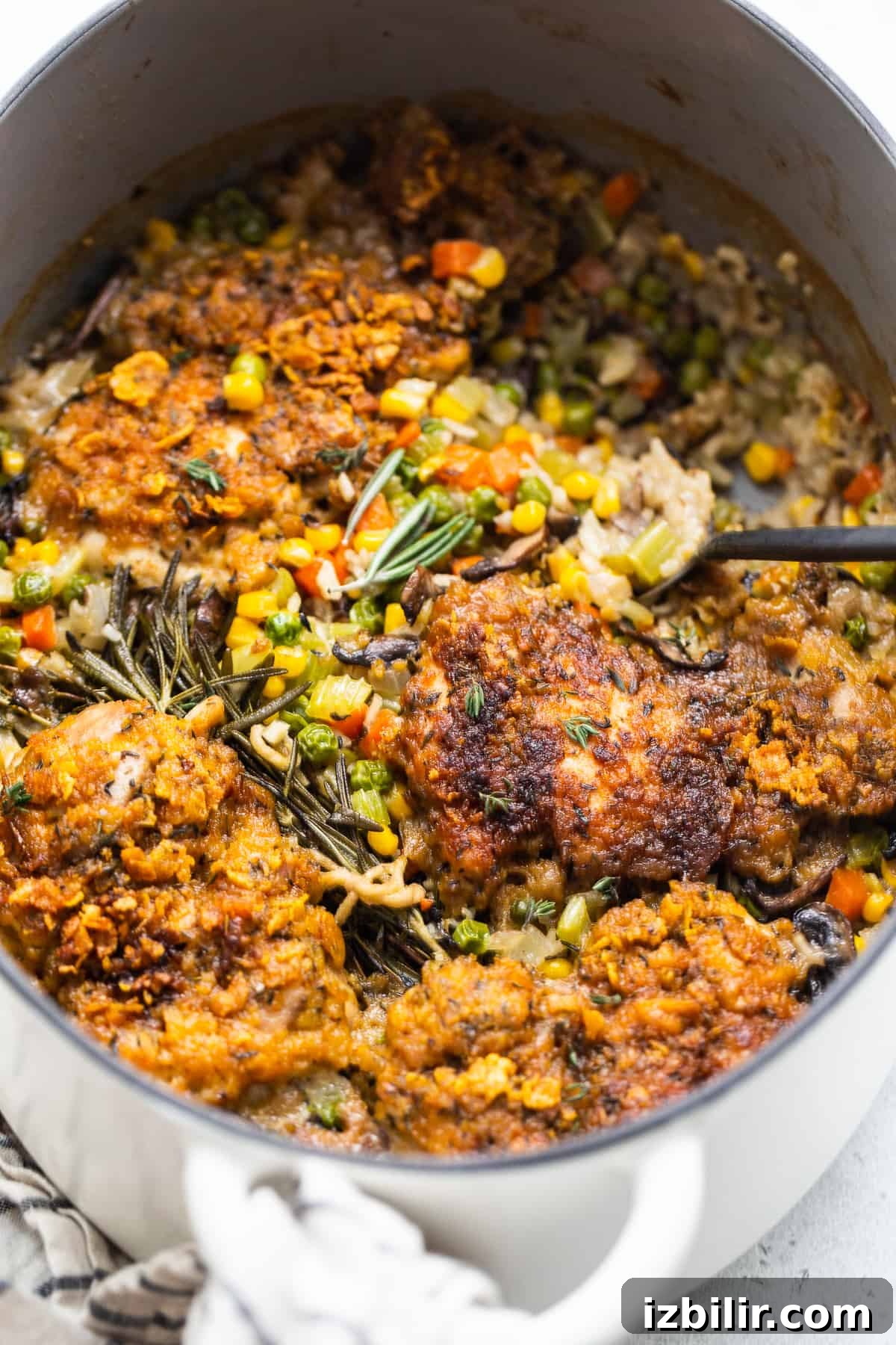 Scooping chicken pot pie skillet.