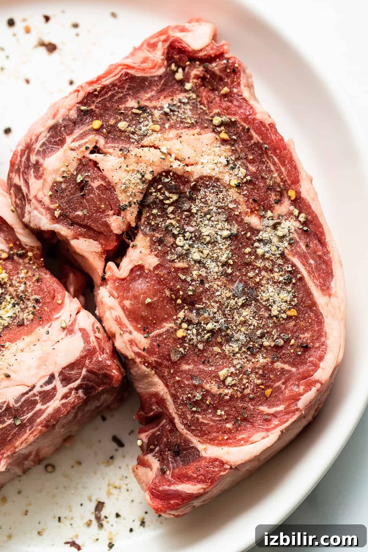 Steak seasoning applied to raw steak Steak seasoning on raw steak.