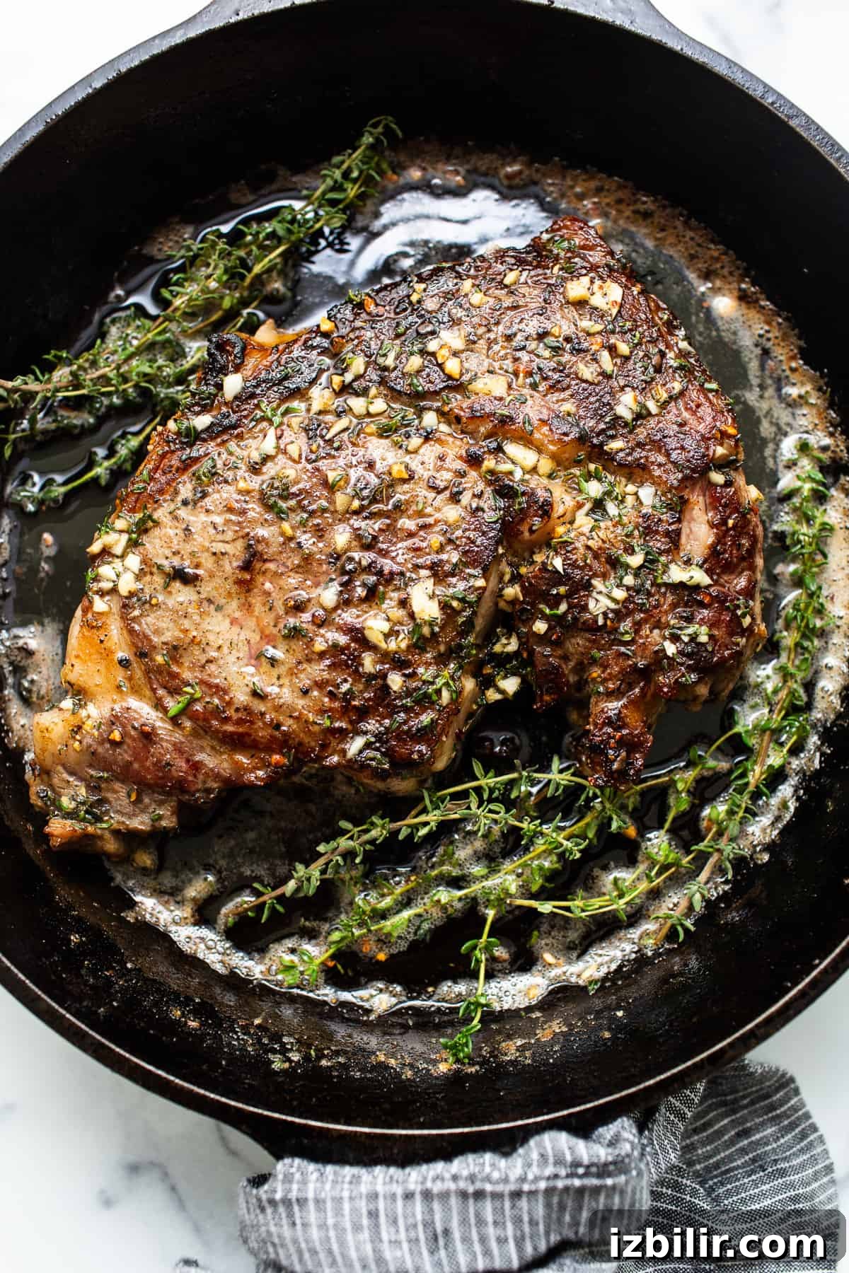 How to Make Restaurant-Style Cast Iron Steak at Home 2 A cast iron steak in a pan.