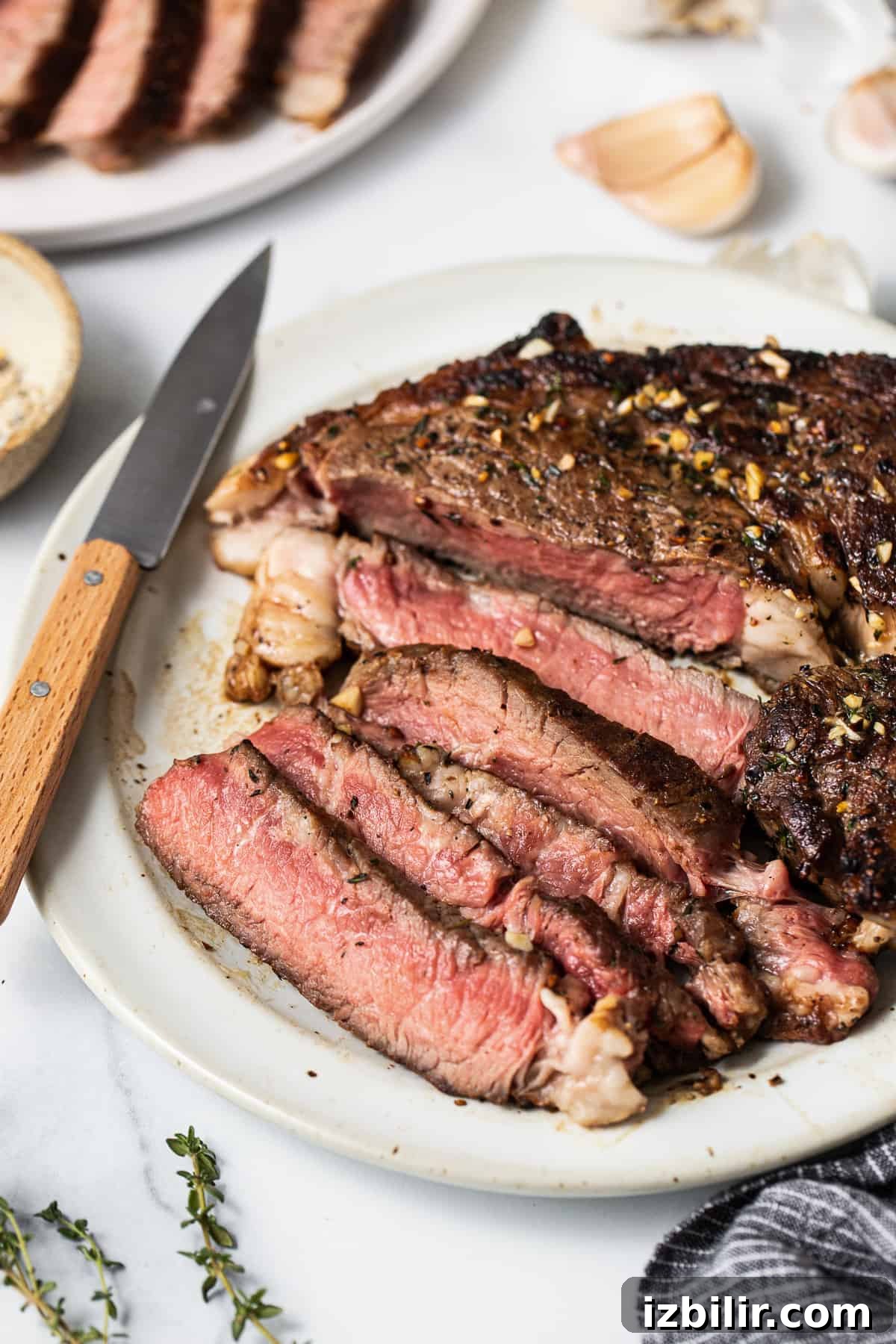 How to Make Restaurant-Style Cast Iron Steak at Home 7 Sliced steak on a plate.