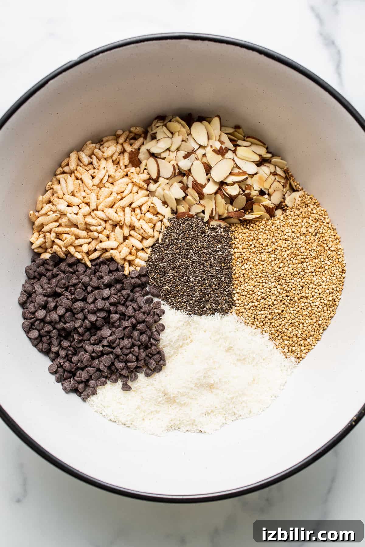 Ingredients for nut and coconut bars in a bowl.
