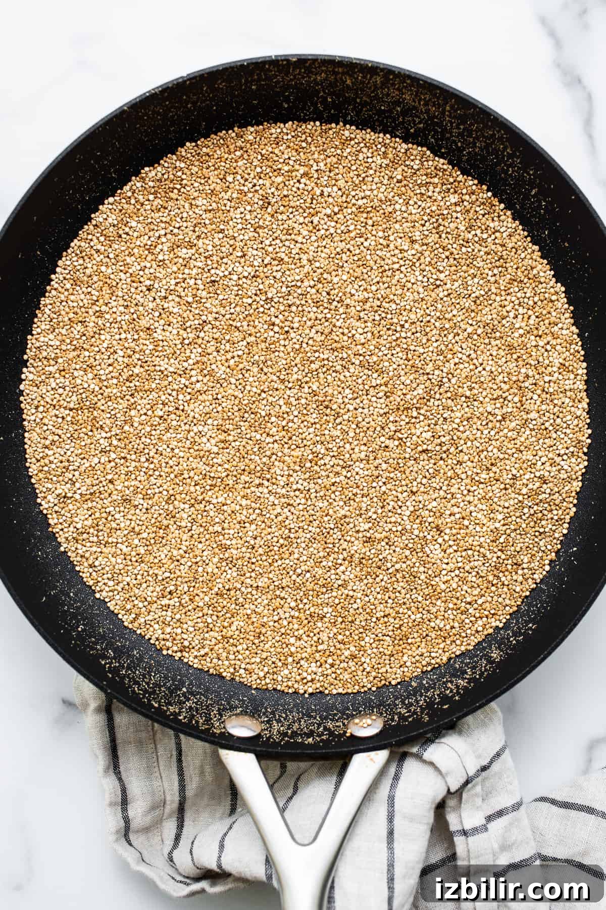 Puffed quinoa in a skillet.