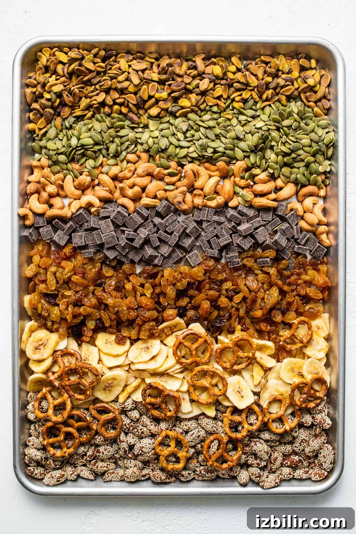 Homemade trail mix ingredients on a baking sheet.