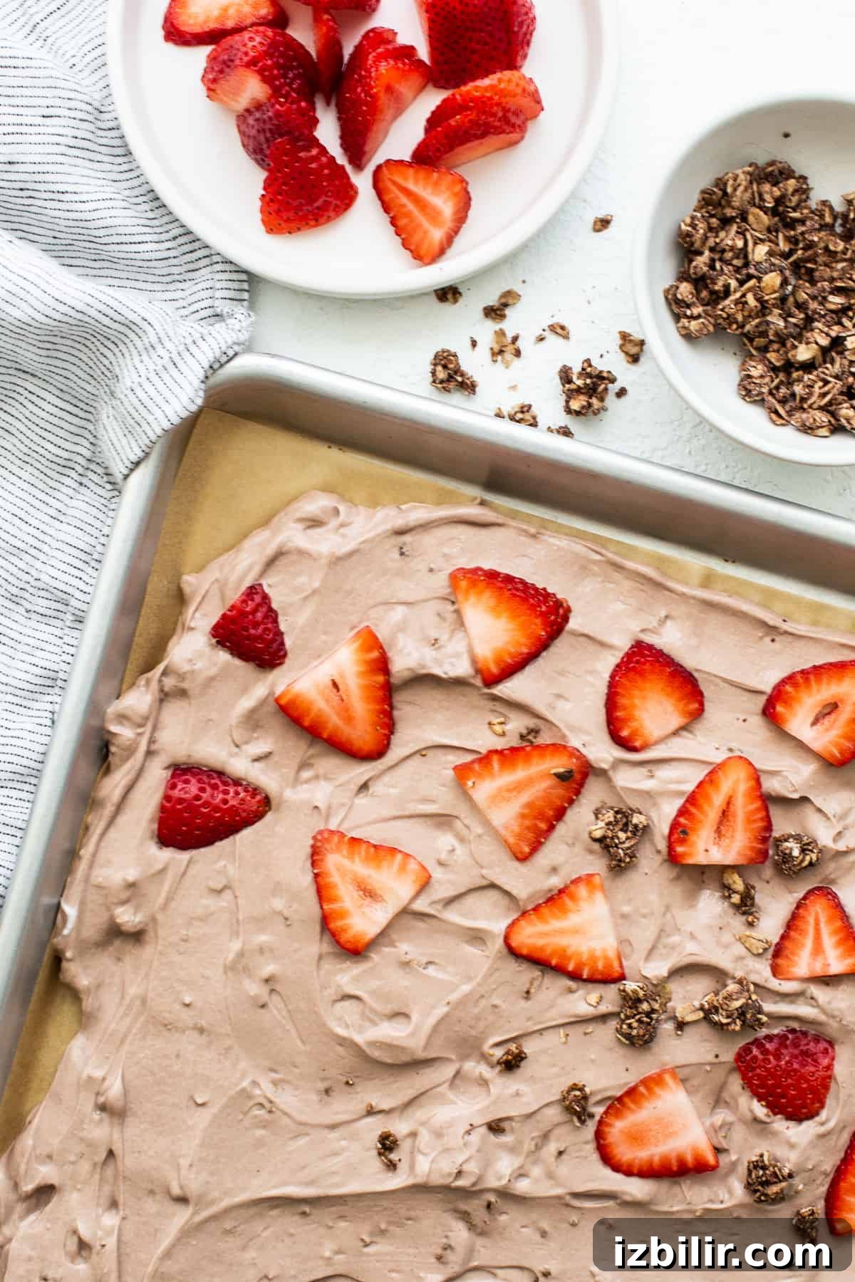 Frozen Yogurt Bark with Strawberries Frozen yogurt bark topped with strawberries.