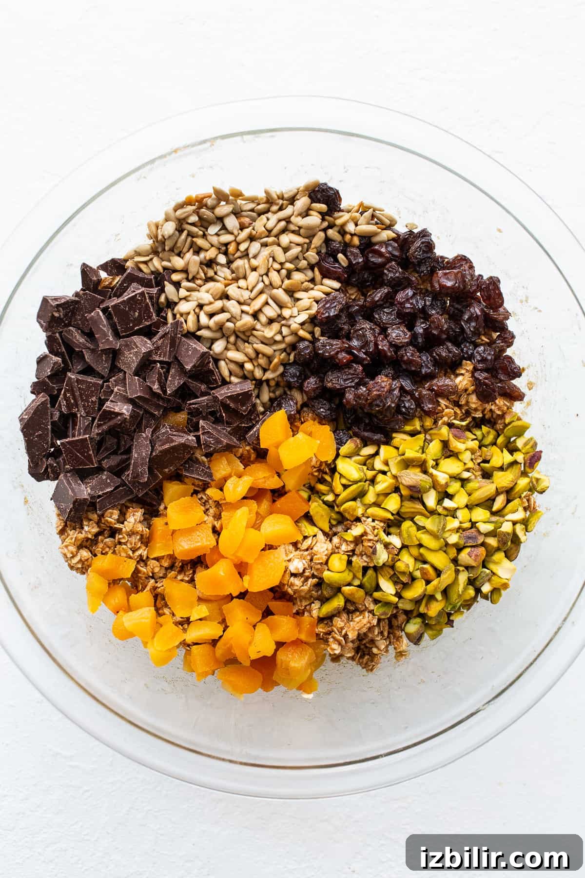 Trail mix cookie ingredients in a bowl.