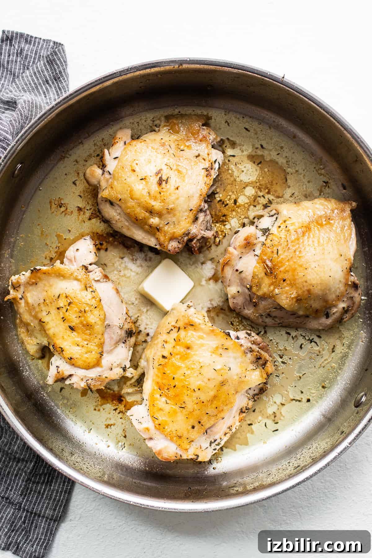 Chicken thighs searing in a skillet Chicken thighs searing in a skillet.