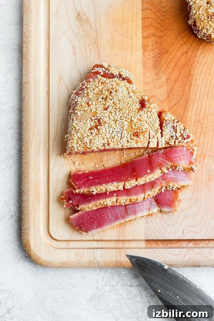 Seared ahi tuna steak on a cutting board. Seared ahi tuna steak on a cutting board.