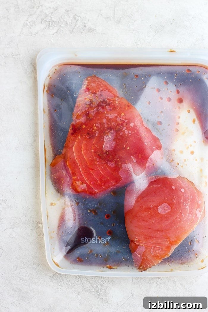 Ahi tuna being marinated. Ahi tuna steak being marinated.