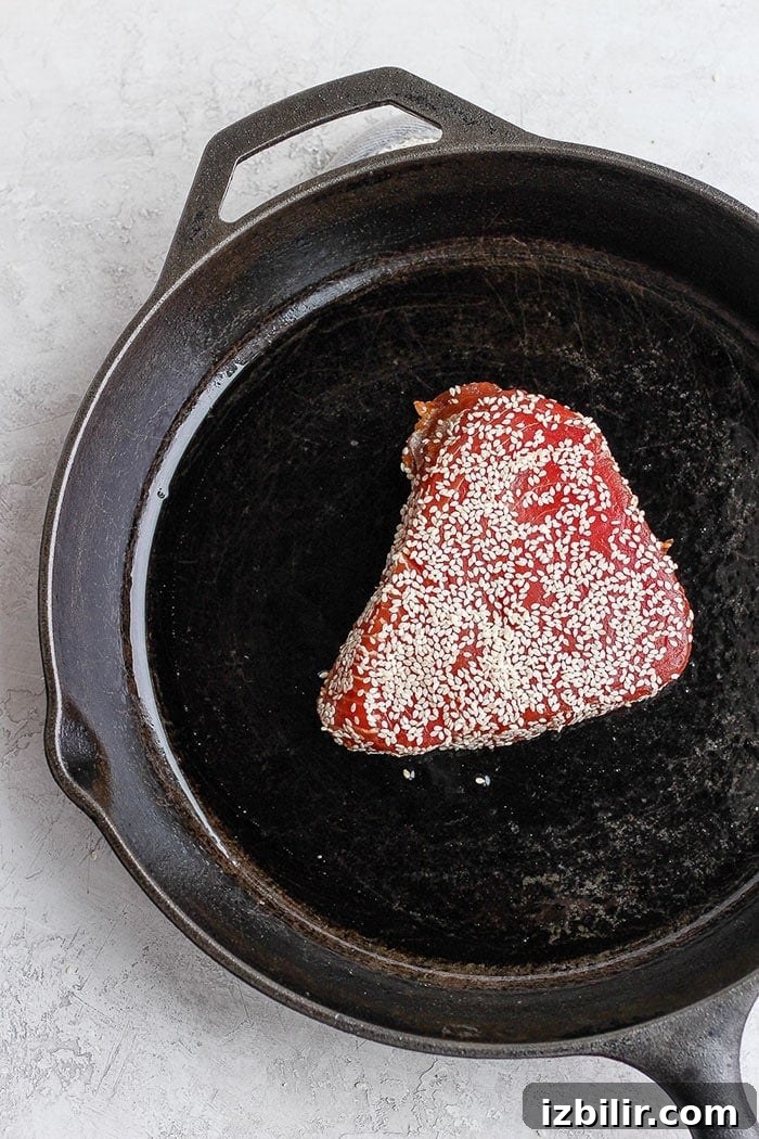 Ahi tuna being seared in a cast iron skillet. Ahi tuna being seared in a cast iron skillet.
