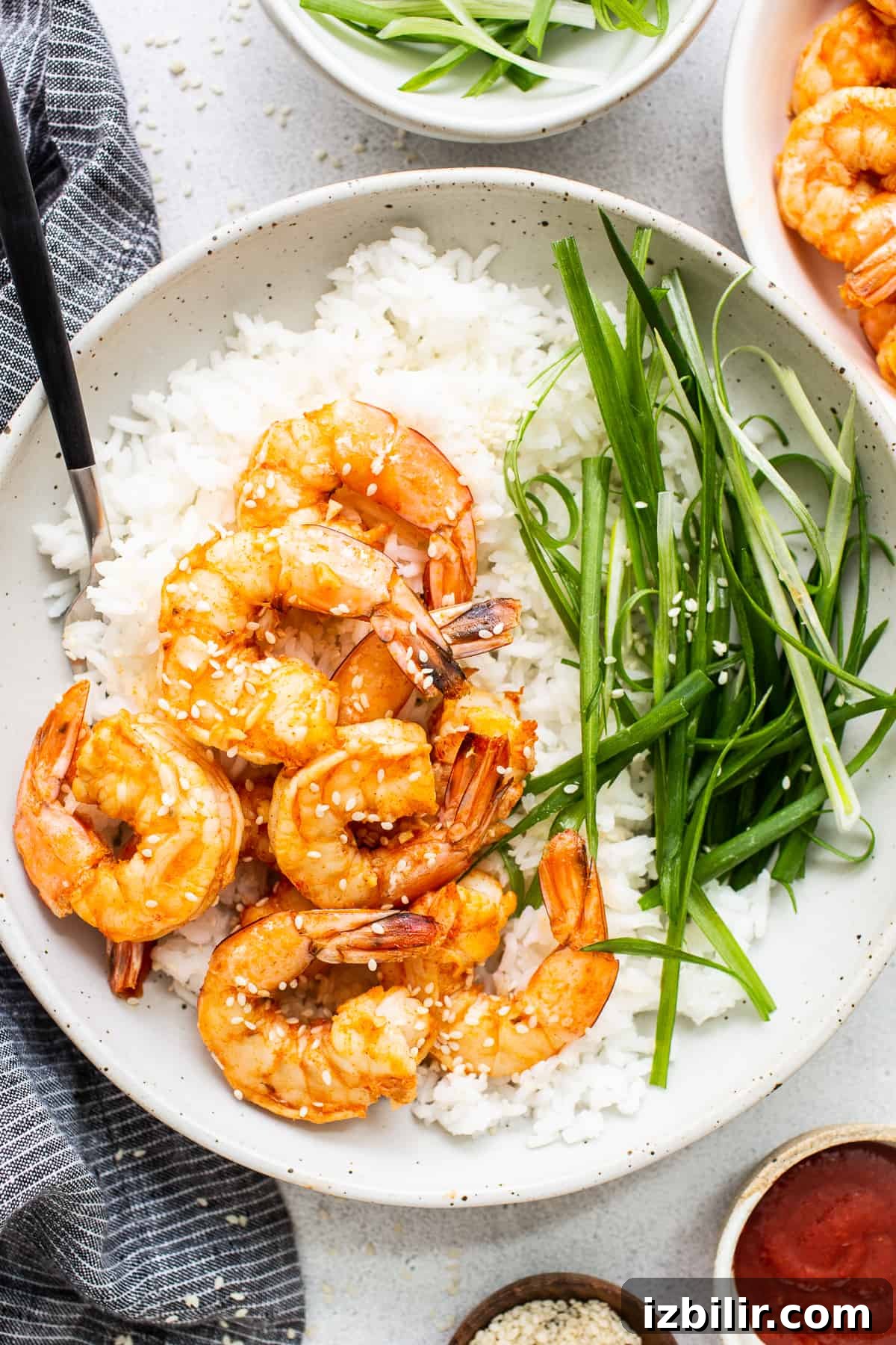 Spicy garlic prawns in a bowl with rice.