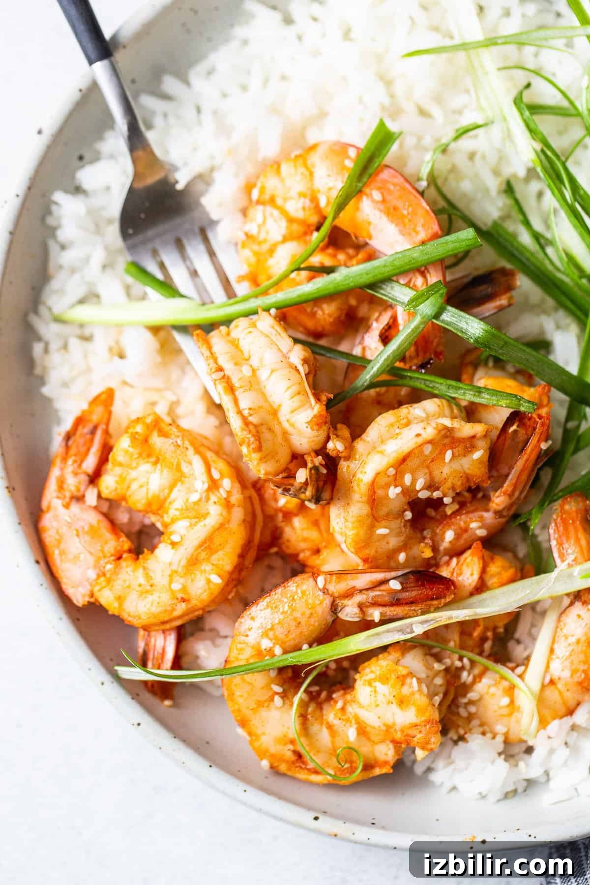 Spicy garlic prawns in a bowl with rice.
