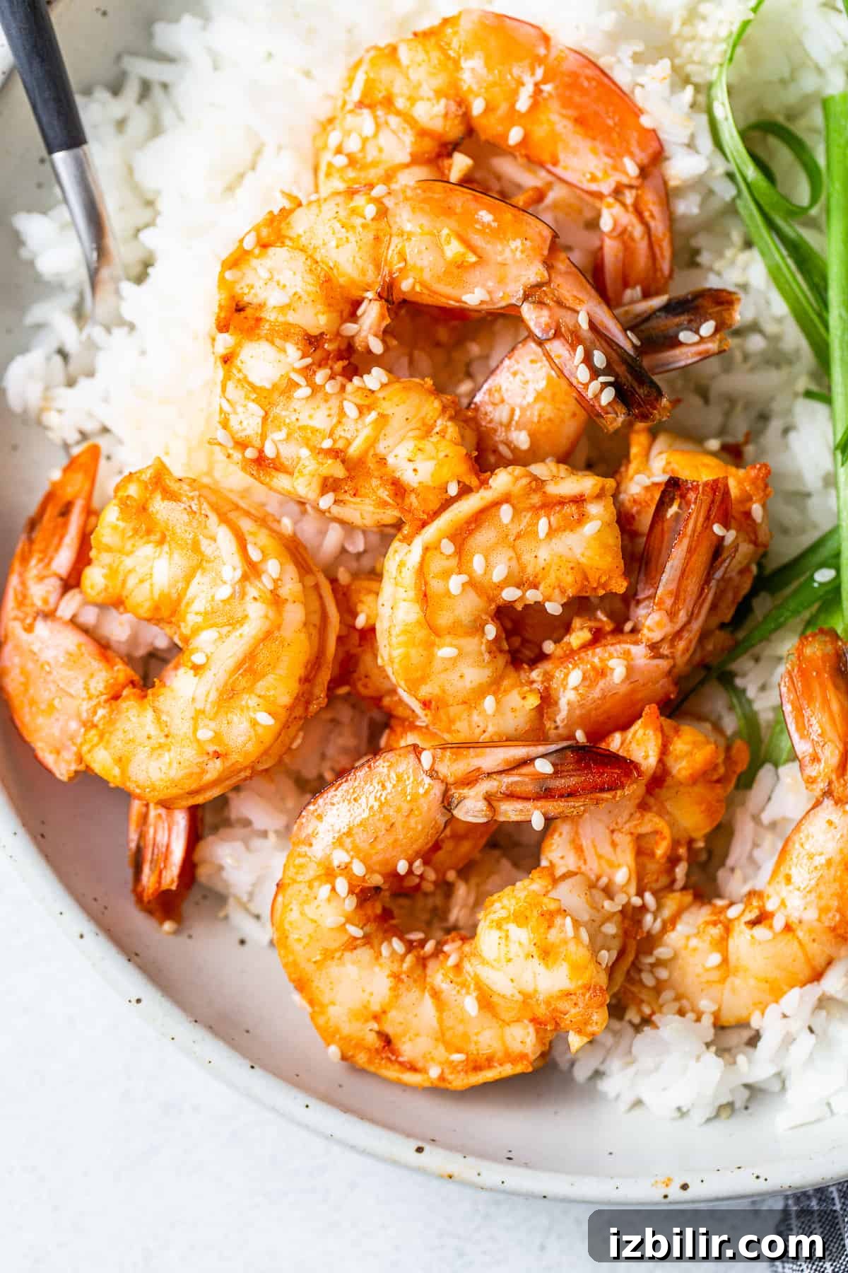 Spicy garlic prawns in a bowl with rice.