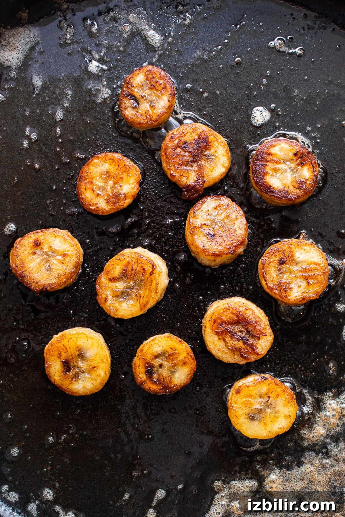 Bananas Foster Muffins are made with a delicious banana muffin base and sweet, caramelized bananas on top for the perfect snack. caramelizing bananas in pan.