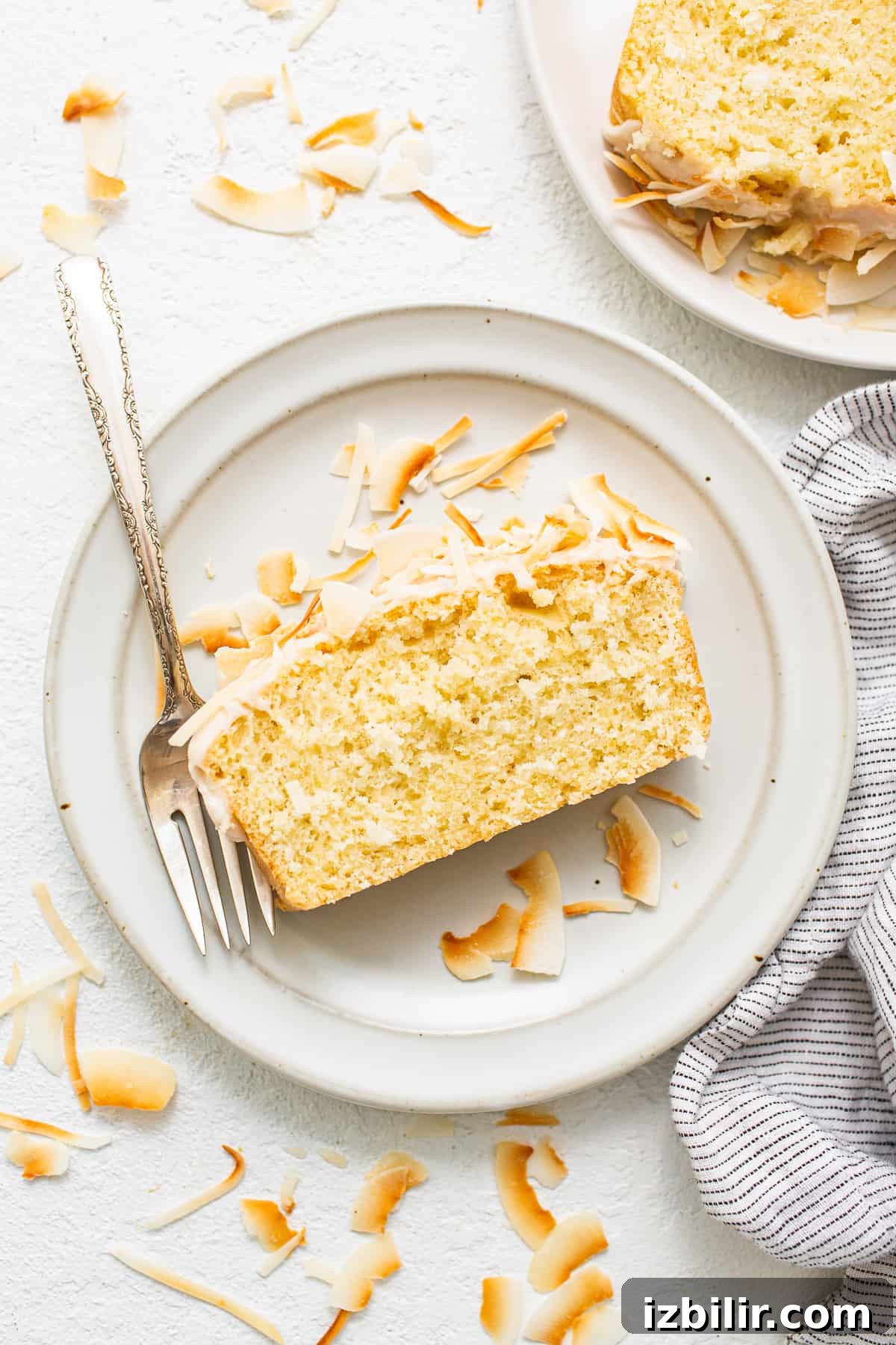 slice of coconut cake on plate.