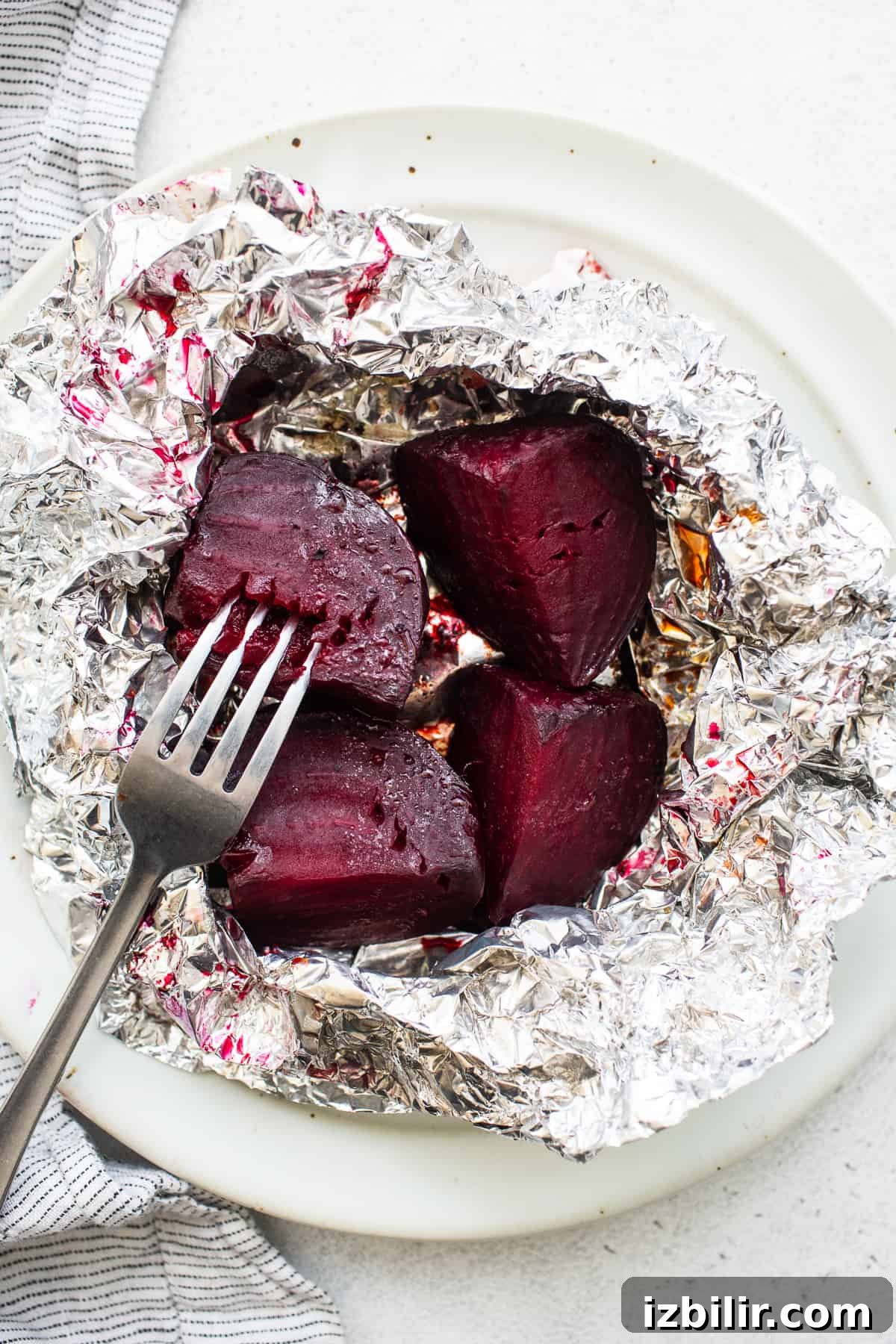 Roasted beets with a fork in them.