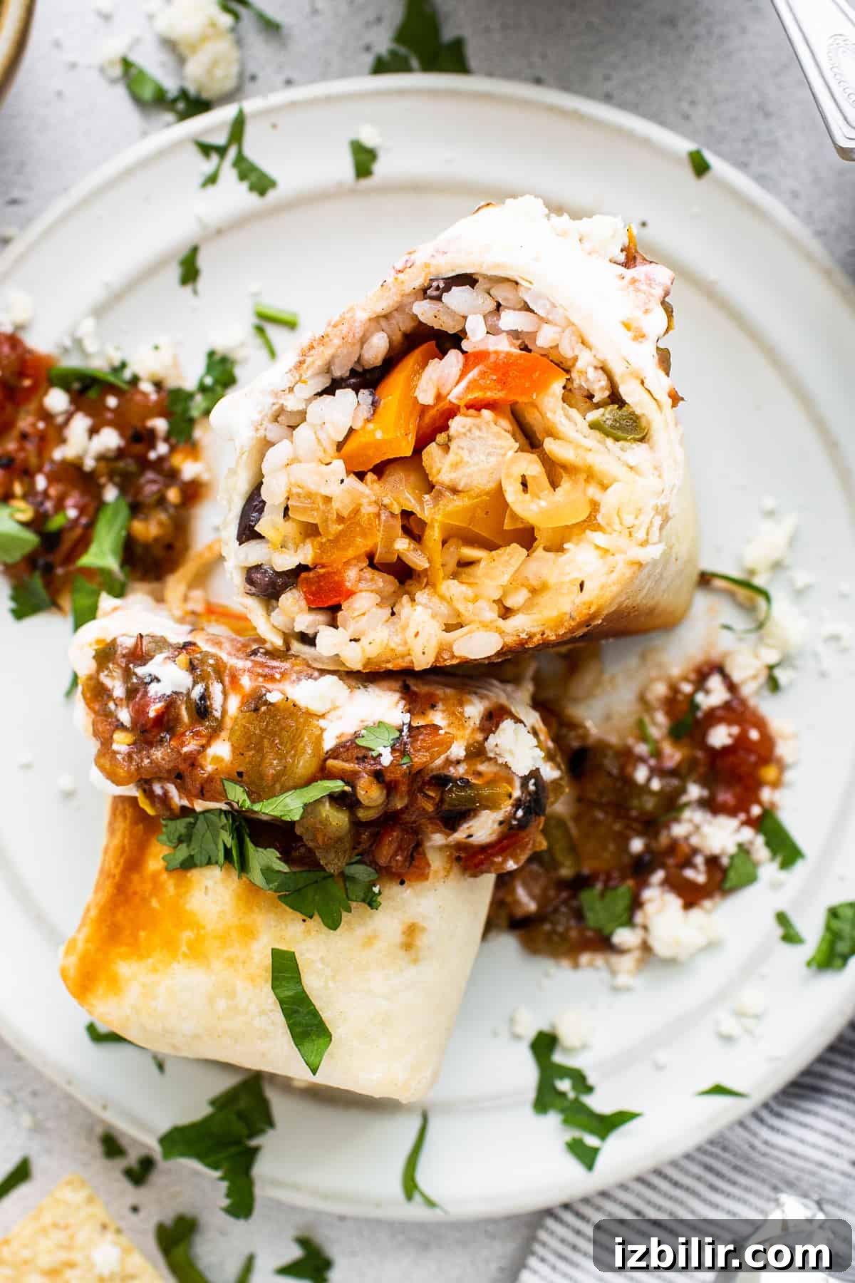 Chicken Fajita Burrito Recipe with Peppers and Onions 7 Chicken fajita burrito on a plate.