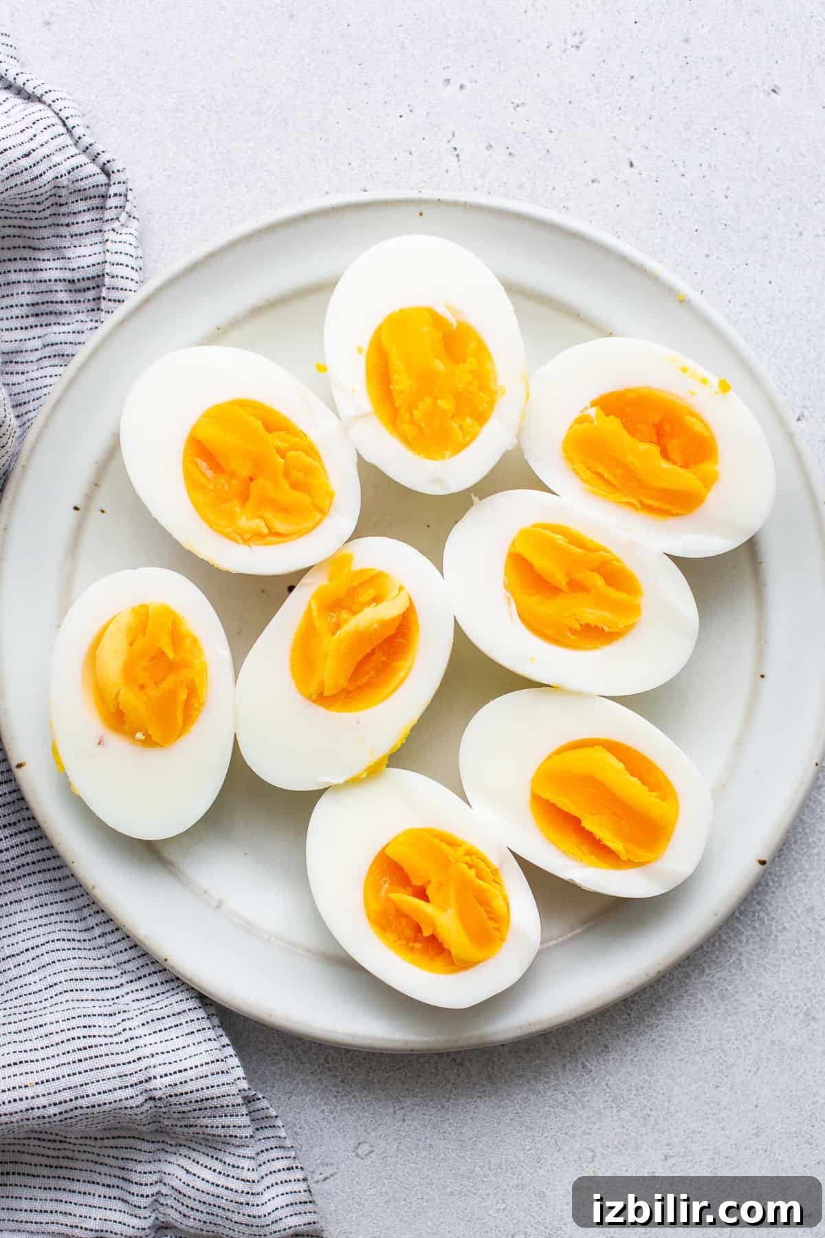 Hard boiled eggs cut in half on a plate.