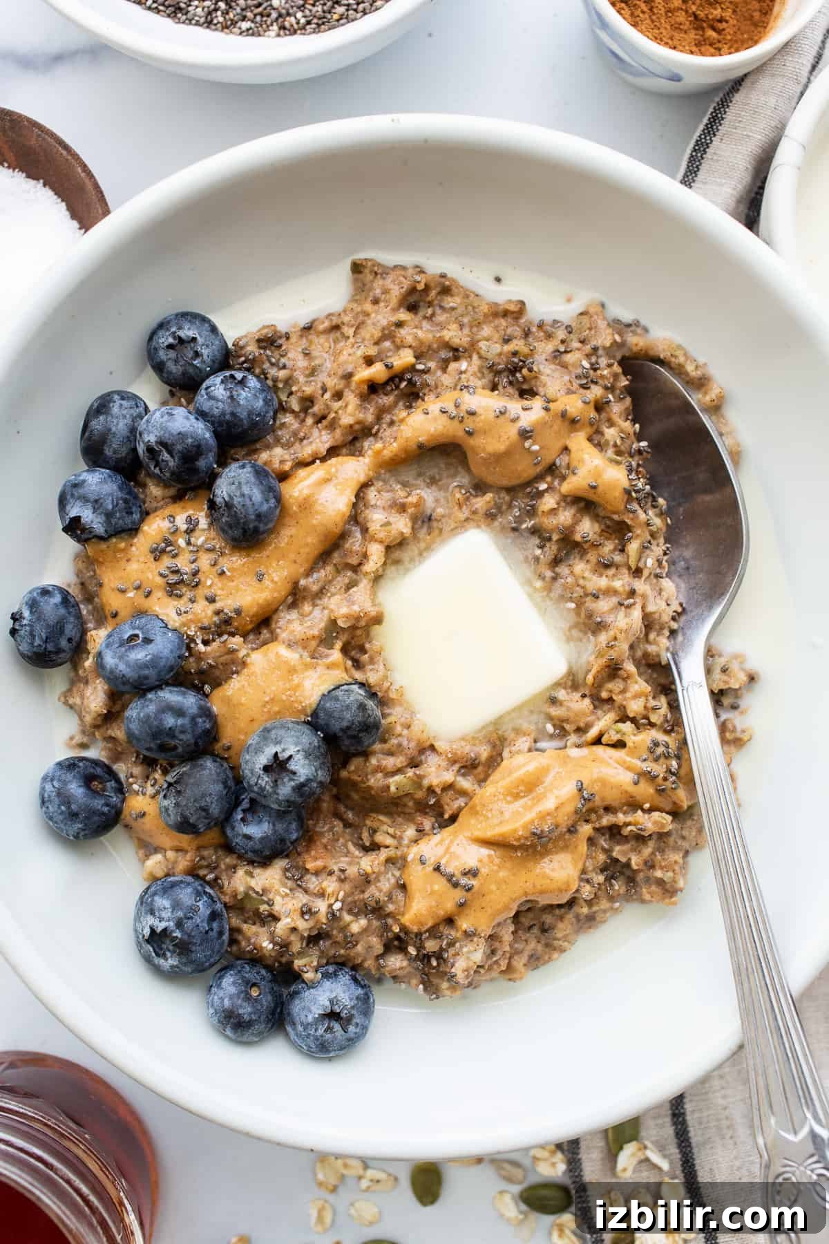 Porridge in a bowl topped with blueberries.