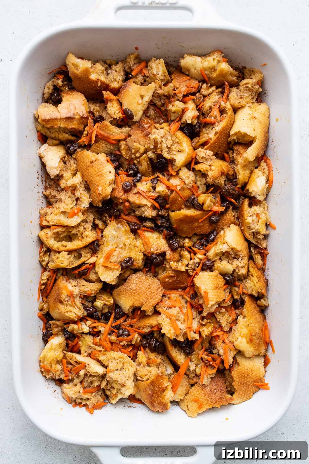 Carrot cake french toast casserole mixed together in a casserole dish.