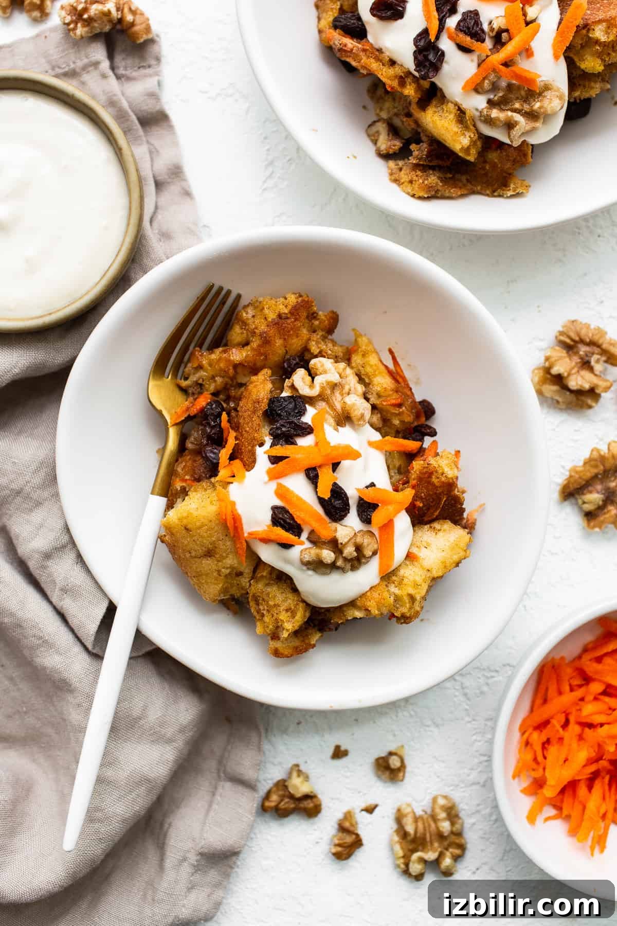 Carrot cake french toast casserole on a plate with a fork.