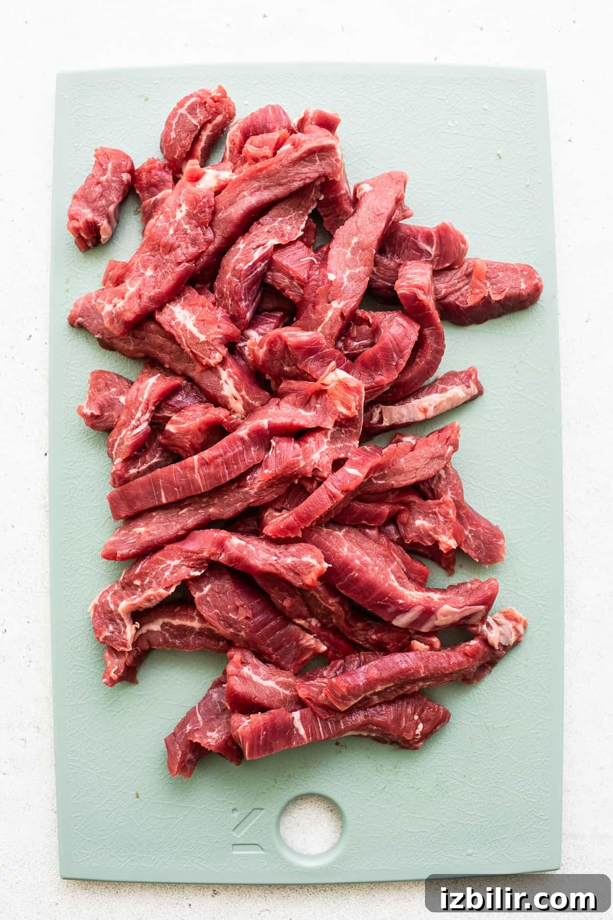 sliced beef on cutting board.