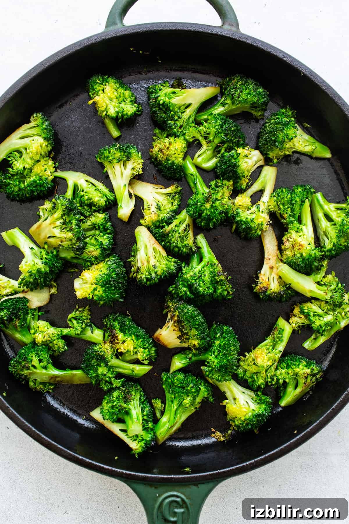 sauteed broccoli on cast iron pan.