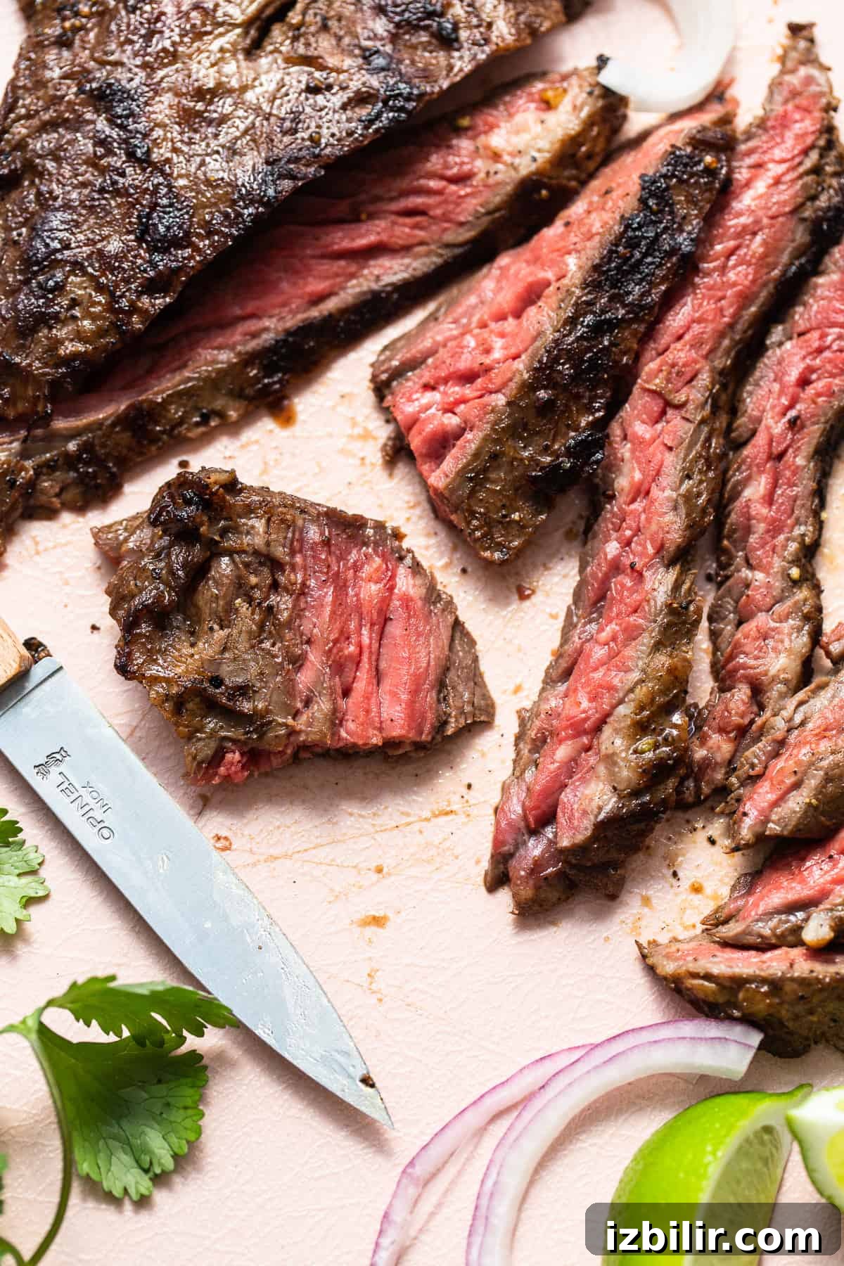 Sliced skirt steak with knife Sliced of skirt steak and a knife.
