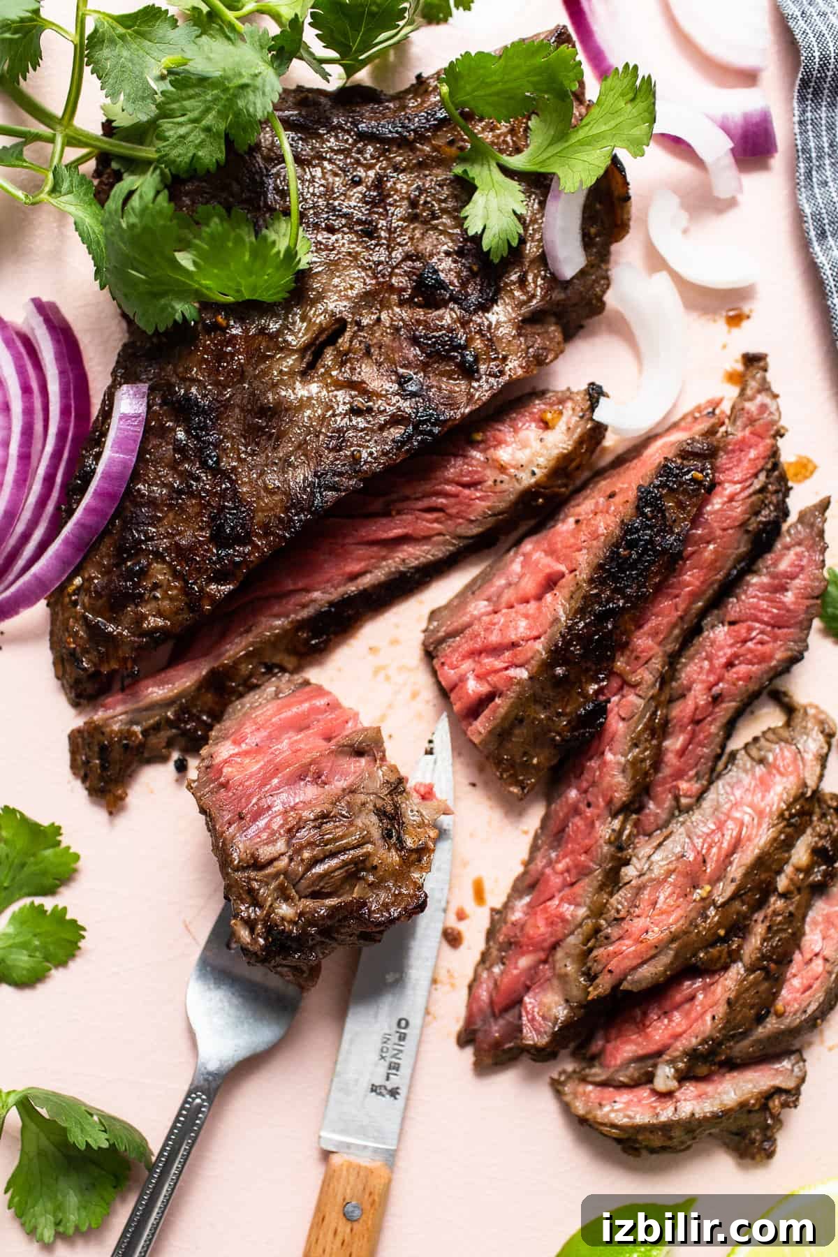 Cutting skirt steak Sliced skirt steak being cut with a knife.