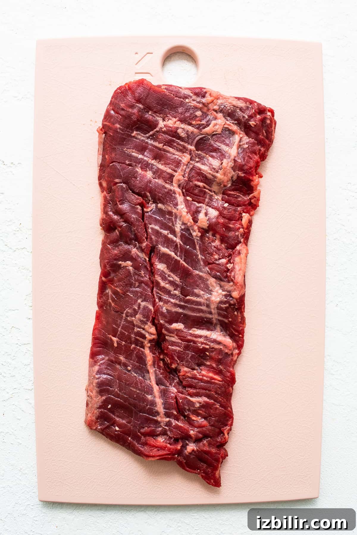 Raw skirt steak Raw skirt steak on a cutting board.