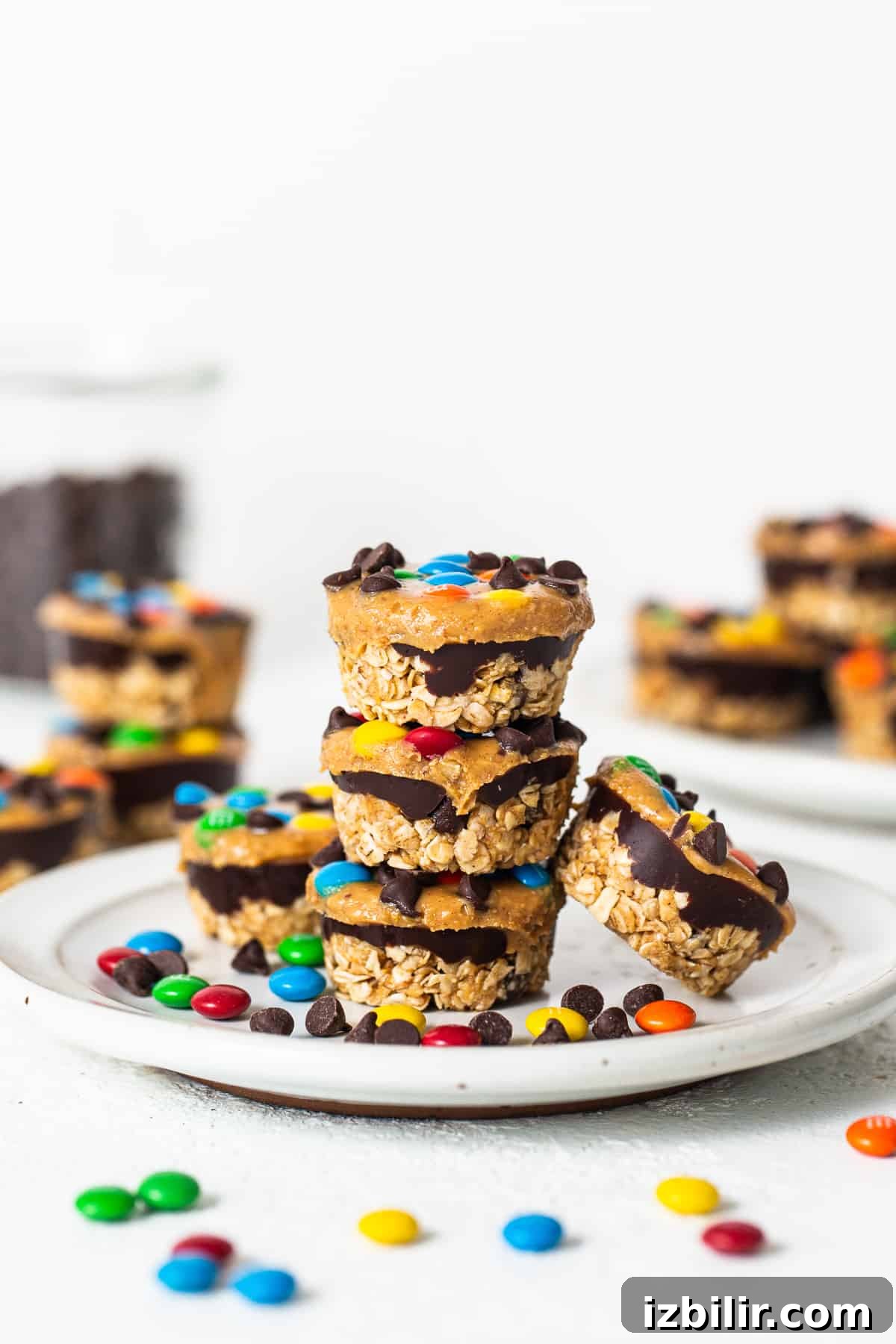 No-Bake Monster Cookie Oat Cups with Peanut Butter & M&Ms 14 Monster cookie oat cups stacked on a plate.