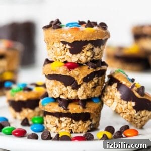 No-Bake Monster Cookie Oat Cups with Peanut Butter & M&Ms 15 Monster cookie oat cups stacked on a plate.
