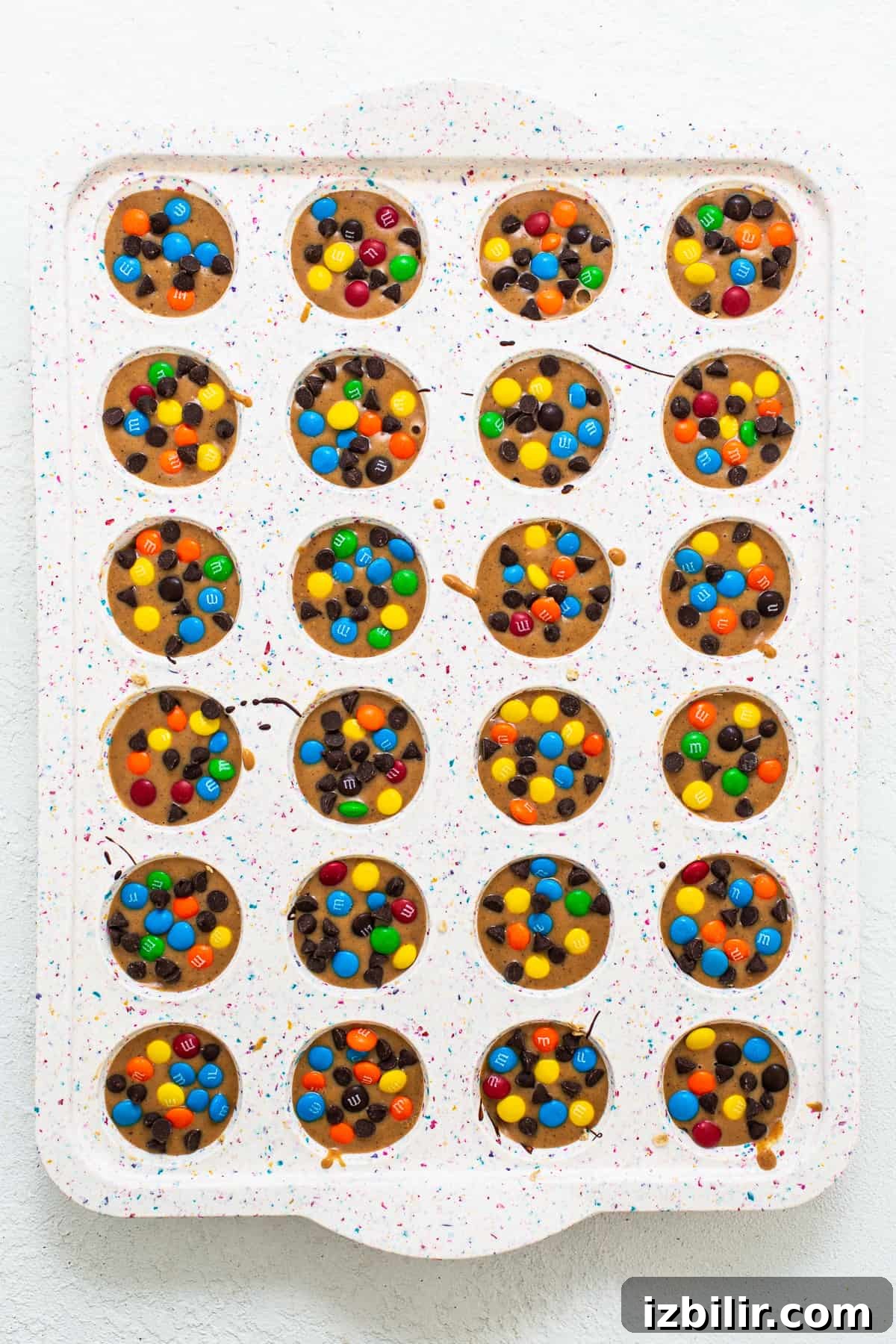 No-Bake Monster Cookie Oat Cups with Peanut Butter & M&Ms 6 Monster cookie oat cups in a mini muffin tin.