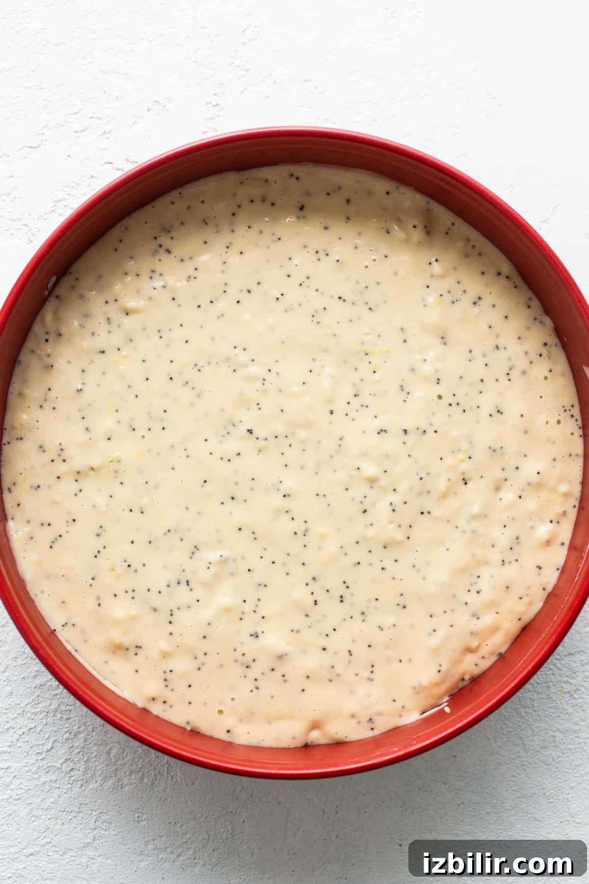 Lemon poppy seed cake batter in a cake pan.