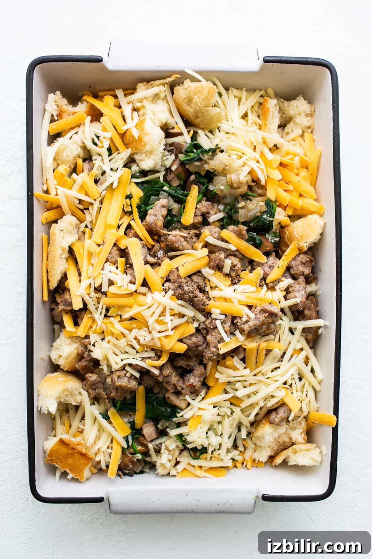 Breakfast strata ingredients in a casserole dish.
