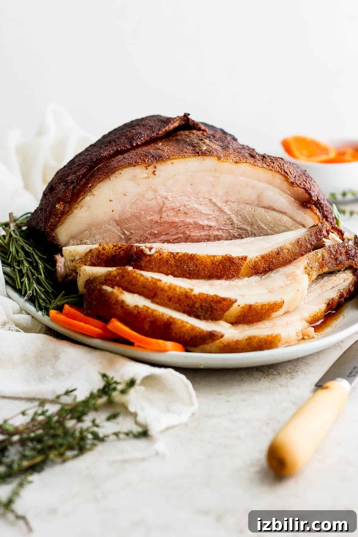 How to Smoke a Juicy Ham 8 Sliced ham on a plate.