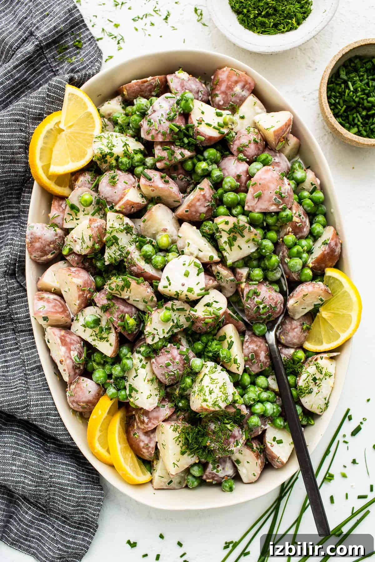 English pea and potato salad in a serving bowl.