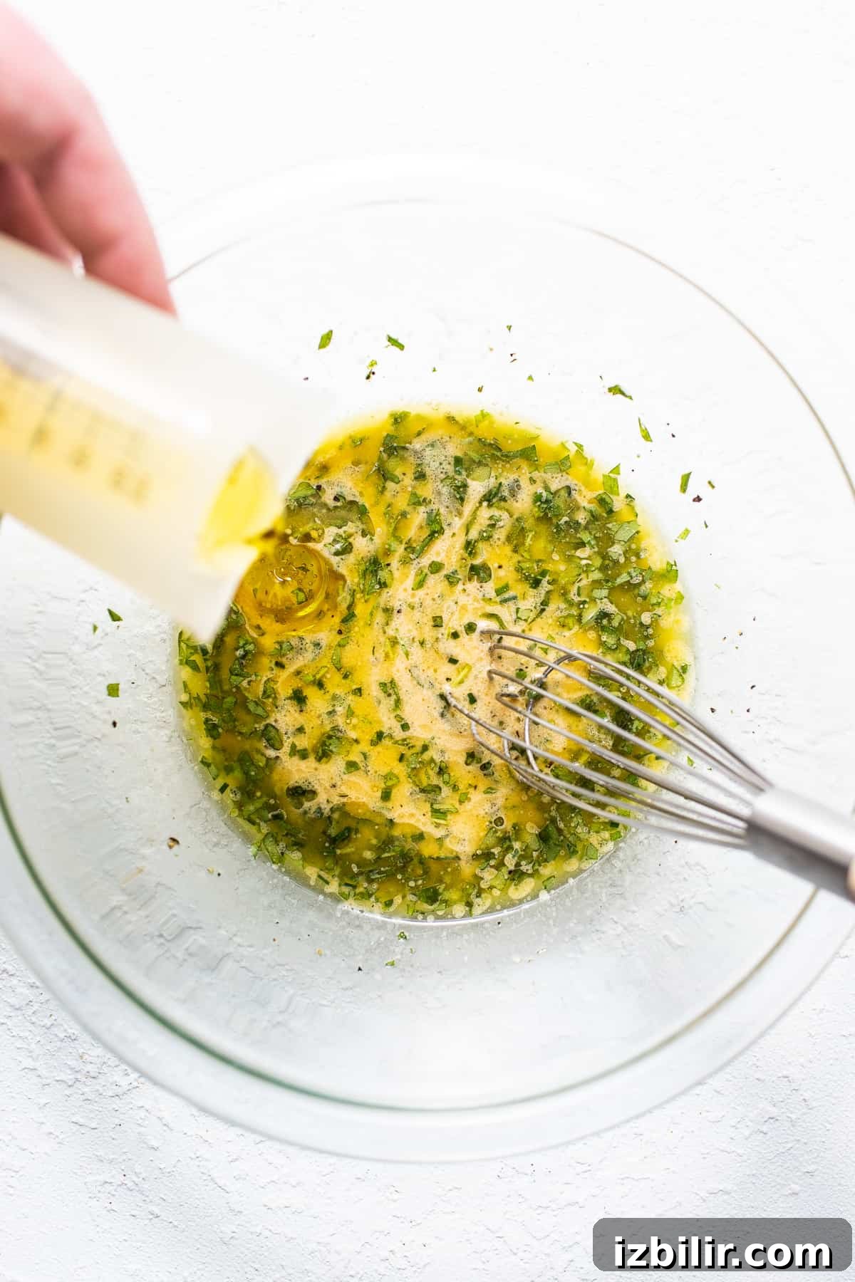 Hummus dressing whisked in a bowl dressing whisked in bowl.