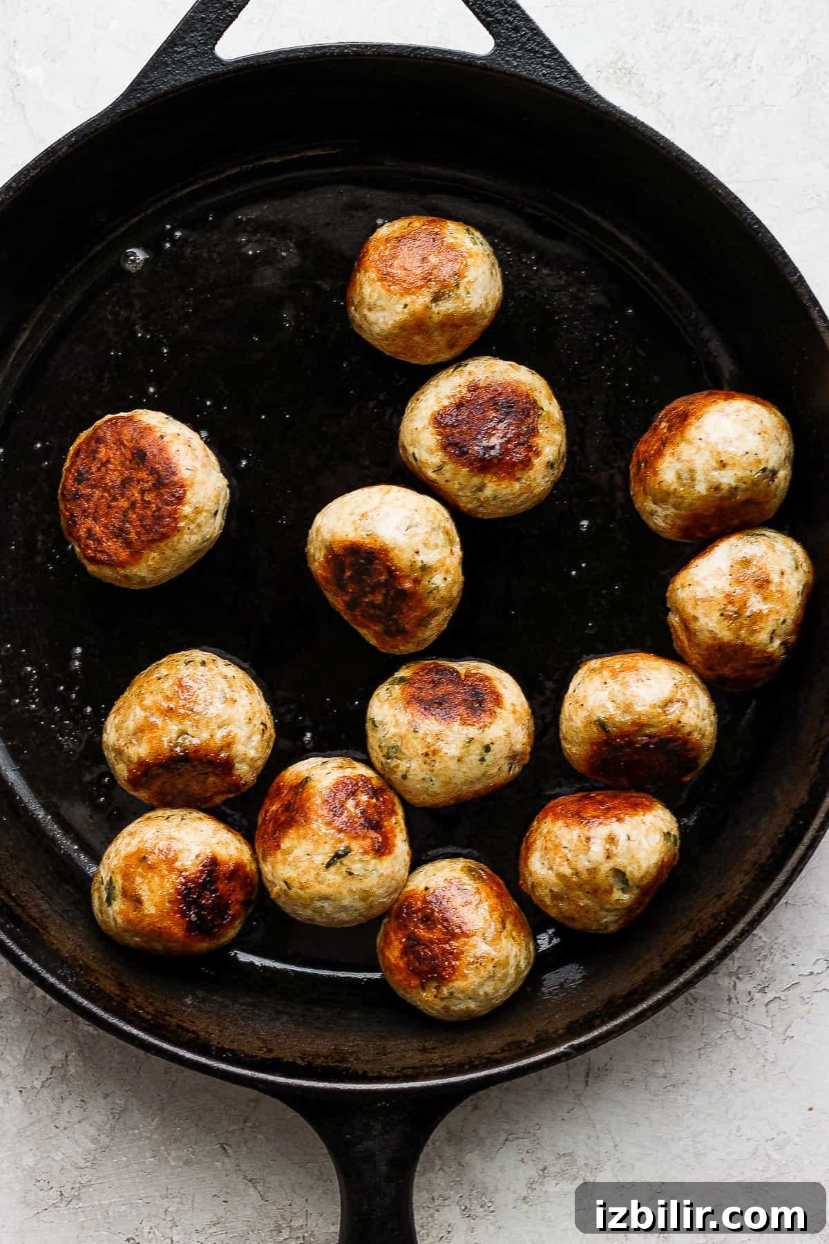 cooking meatballs in cast iron pan