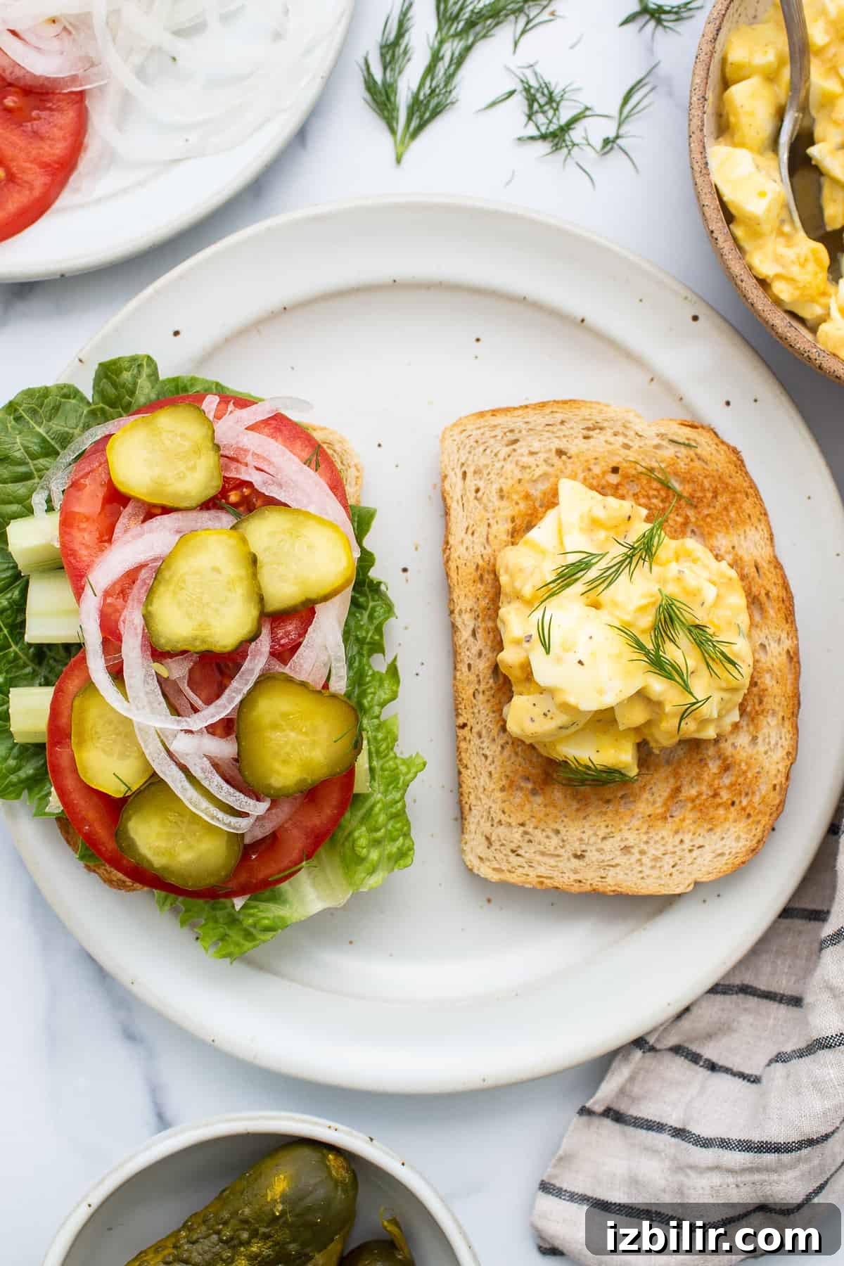 Creamy Homemade Egg Salad Sandwich 3 Egg salad sandwiches on a plate.
