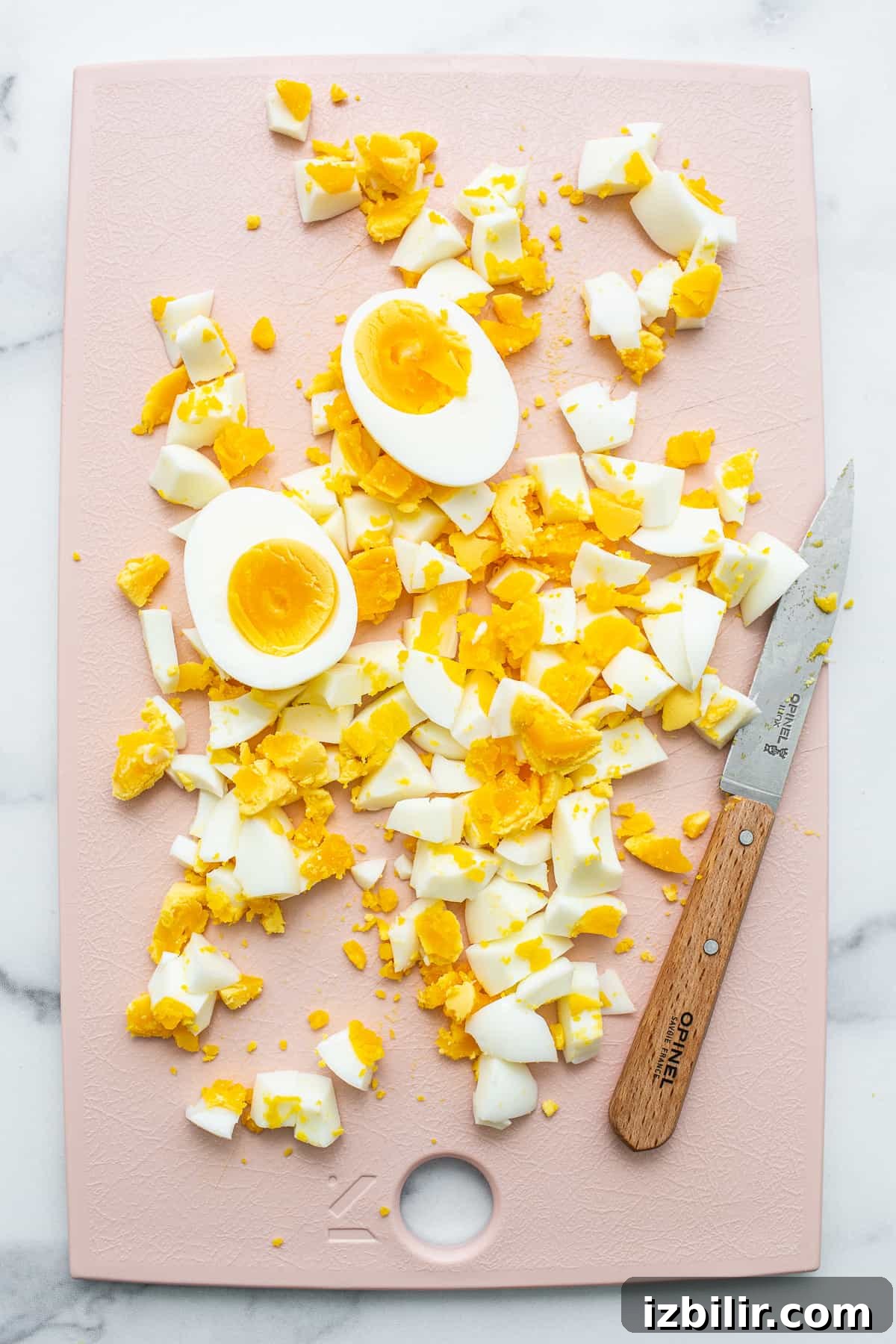 Chopped eggs chopped eggs on cutting board.