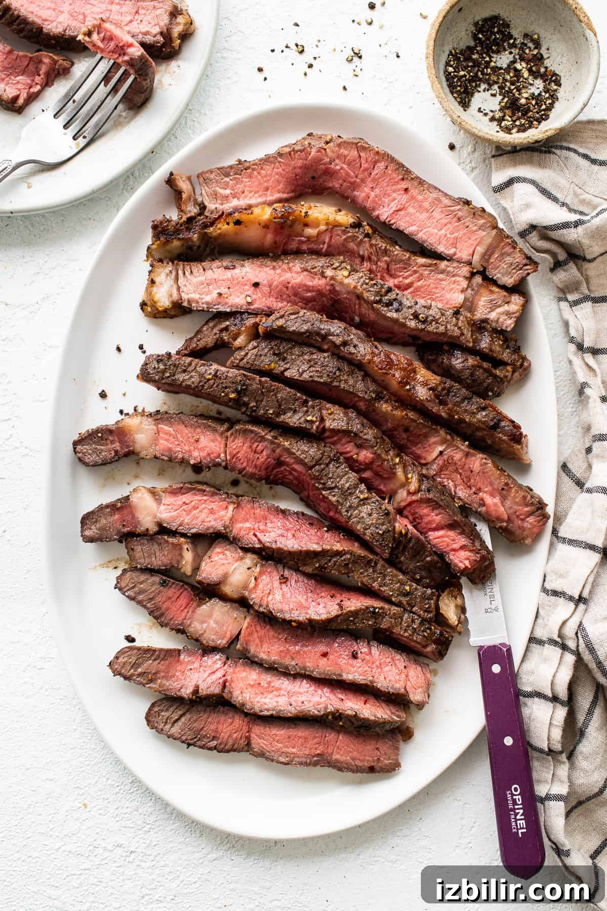 Air fryer steak Sliced air fryer steak on a plate.