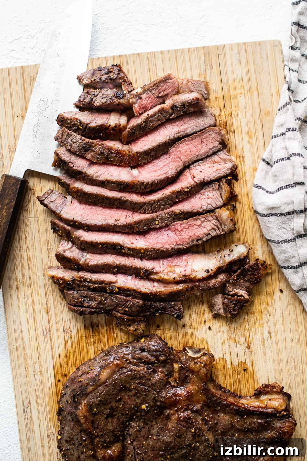 Sliced steak Sliced air fryer steak on a cutting board.
