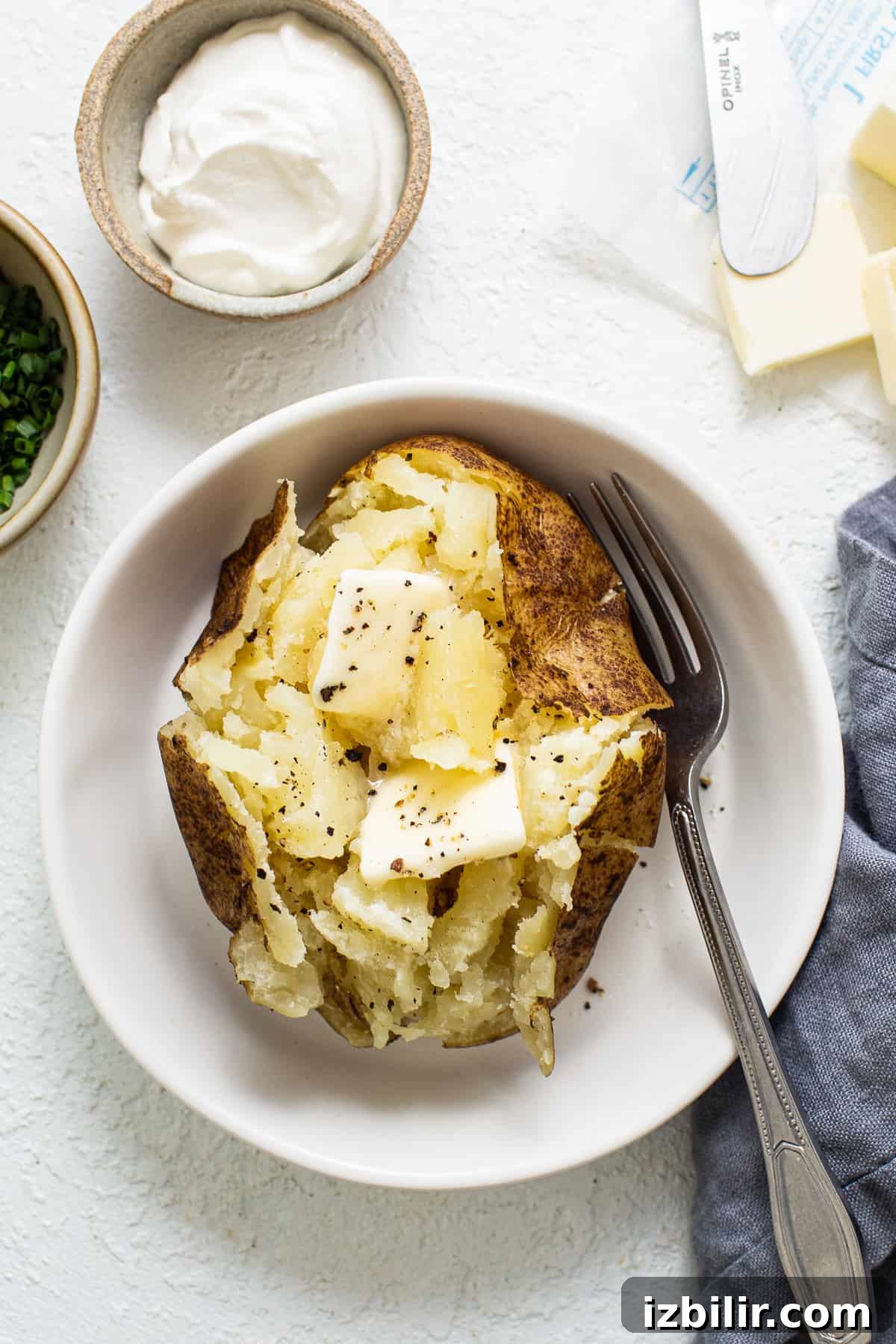 Baked potato with butter baked potato with butter in a bowl.