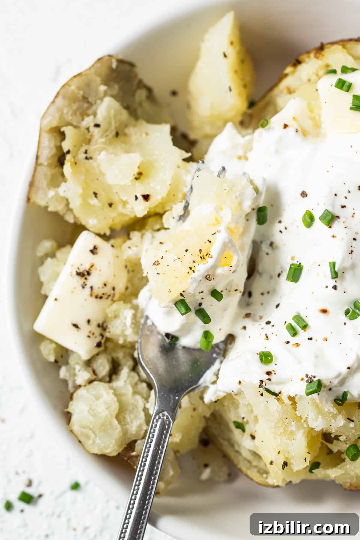 Fluffed baked potato fluffed potato with fork.