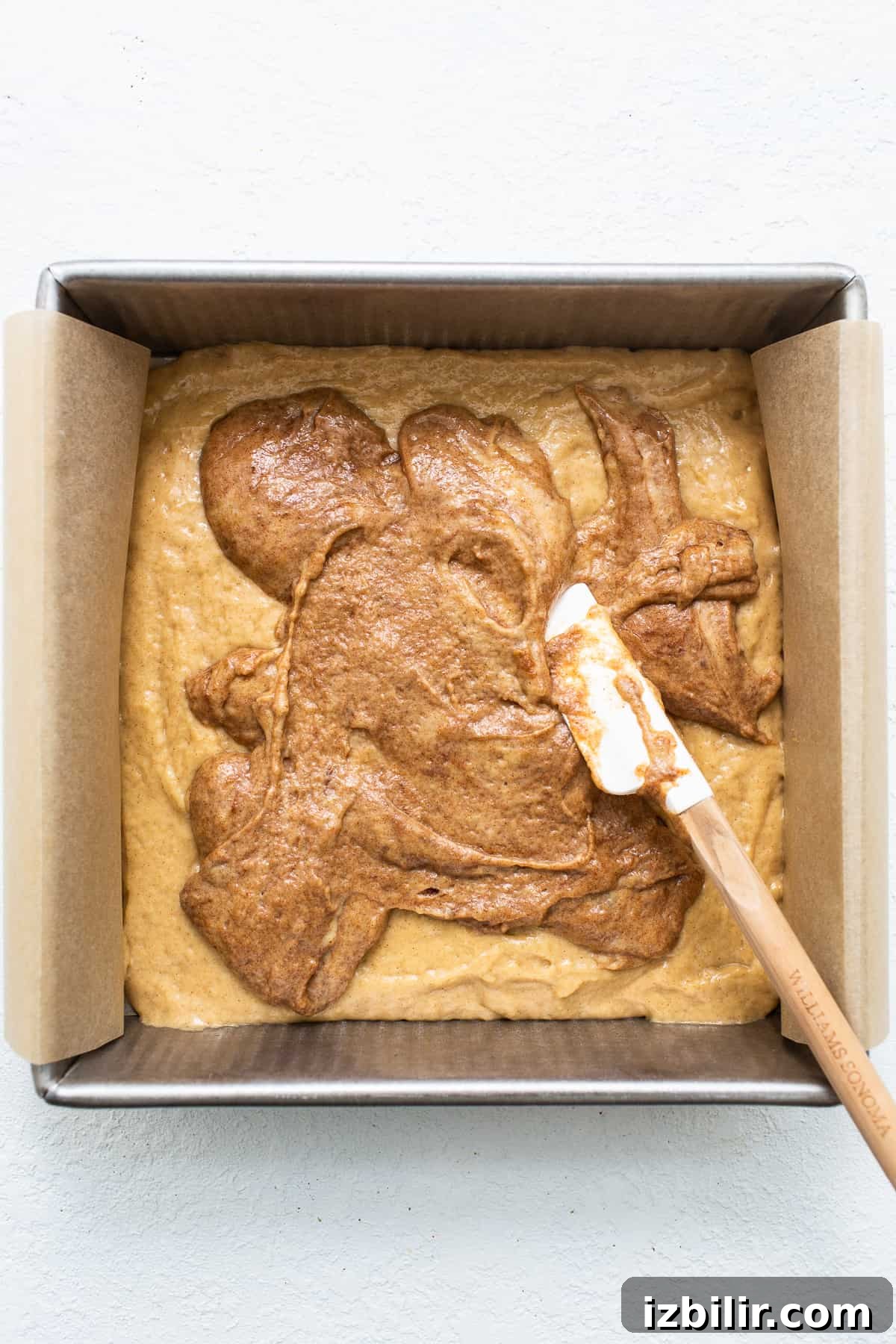 Adding the cinnamon layer to the coffee cake.