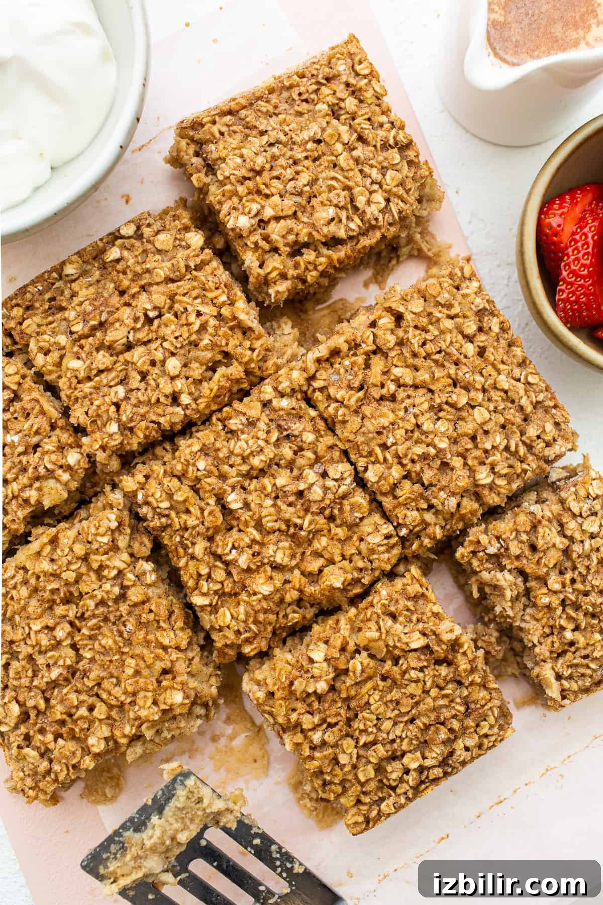Sliced Tres Leches Baked Oatmeal Tres leches baked oatmeal sliced on a cutting board.
