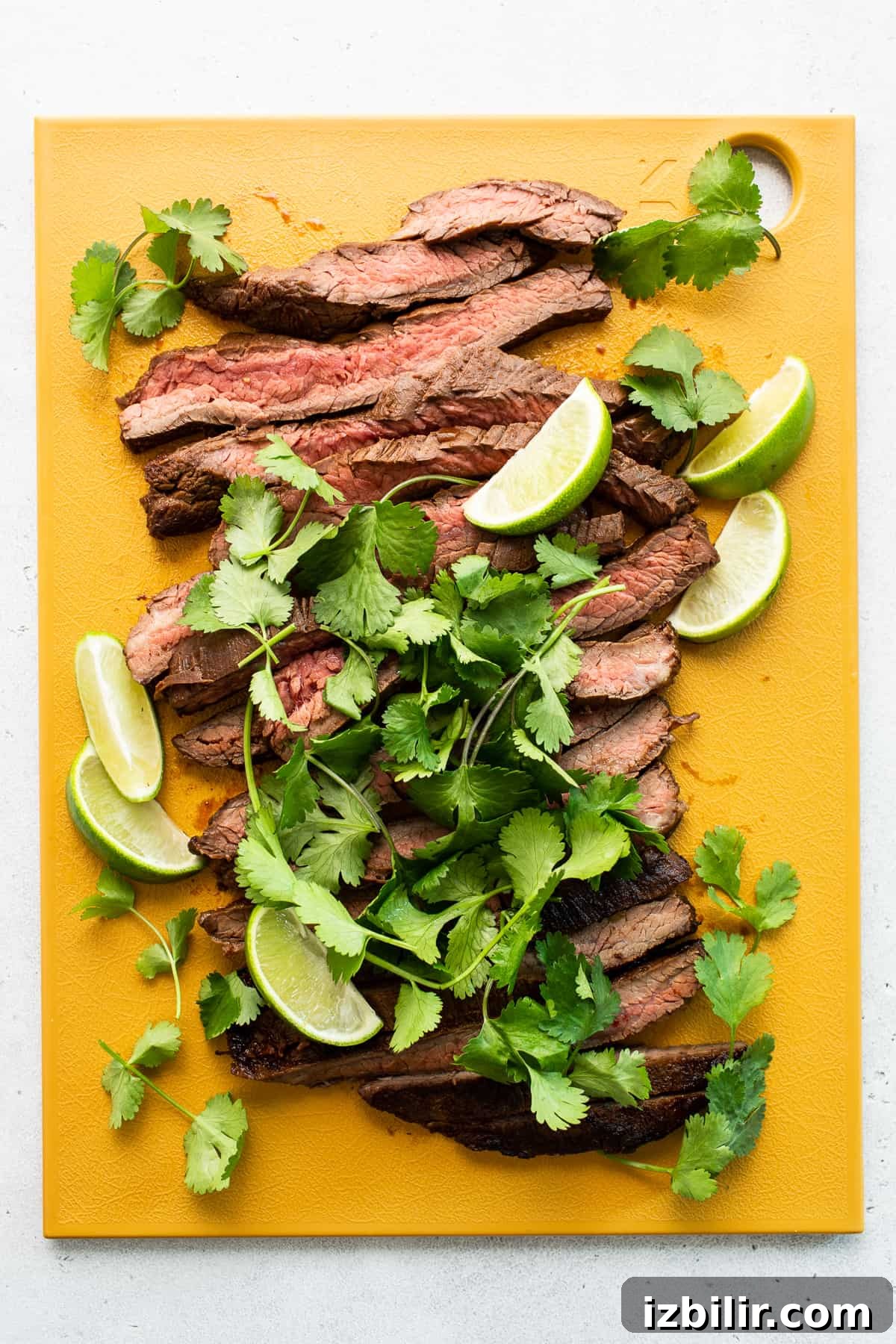 Sliced steak on a cutting board. Sliced steak on a cutting board.