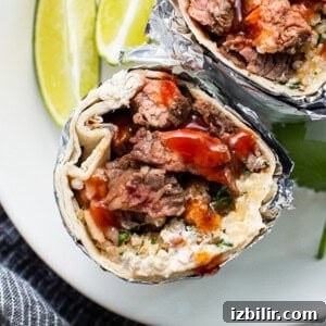 Zesty Steak Fajita Marinade for Juicy, Tender Strips 2 Steak burrito on a plate.